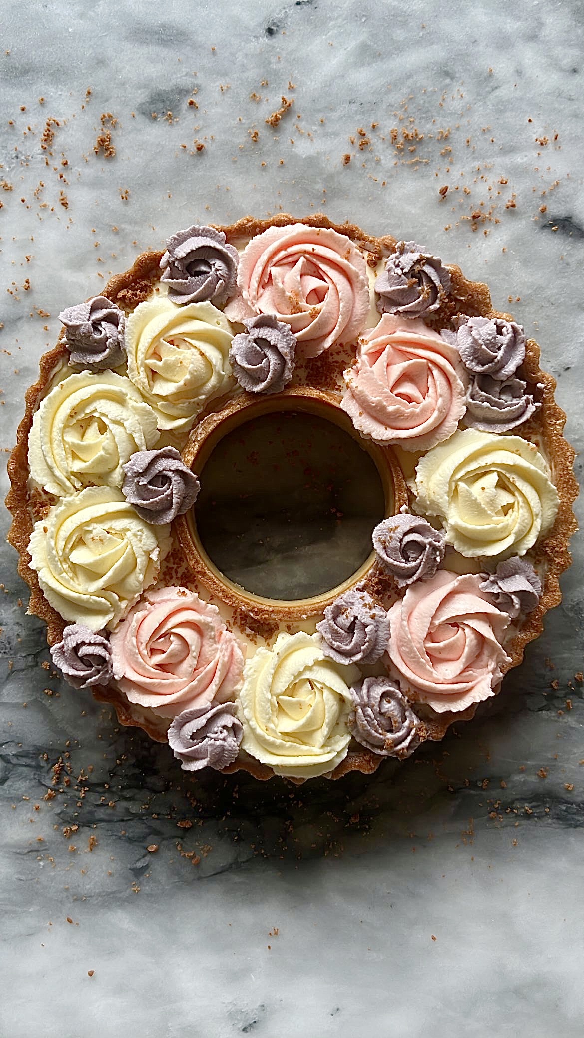 Tart ring topped with flower-shaped piped cream in various colors